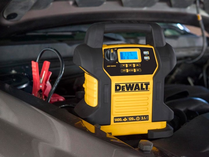 The DeWalt digital portable power station connected to a vehicle's battery.